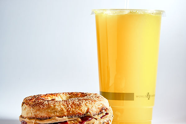 orange juice and PB&J bagel sandwich